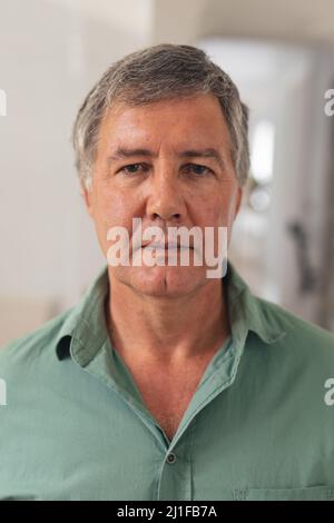 Close-up portrait of serious caucasian senior man at home Stock Photo