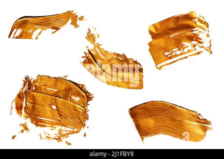 Textured golden strokes isolated on white background. Stock Photo