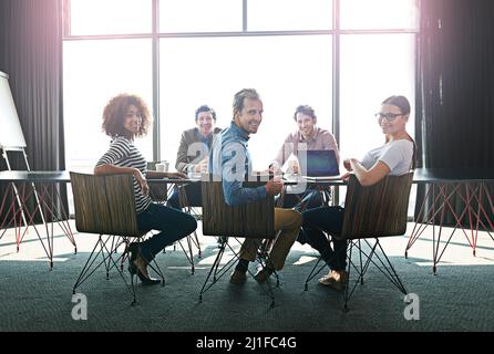 Meeting of like-minded professionals. Portrait of a group of office colleagues sitting around a boardroom table. Stock Photo