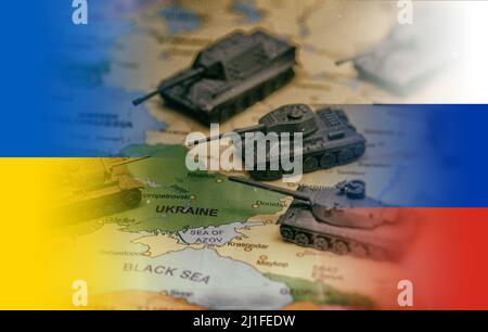 Conflict between Russia and Ukraine. Toy tanks on the map. Stock Photo