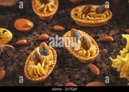 Almond cream cookie decorated with Easter chocolate eggs. Sweet and delicious almond pastry Stock Photo