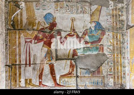 King Seti I receiving the royal flail and crook from the god Horus in the Great Temple of Abydos, Egypt Stock Photo