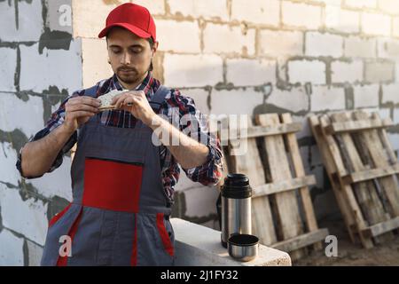 Professional bricklayer during the lunch at the work Stock Photo