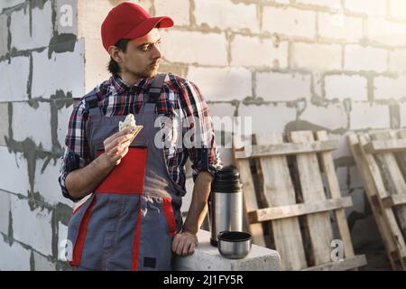 Professional bricklayer during the lunch at the work Stock Photo
