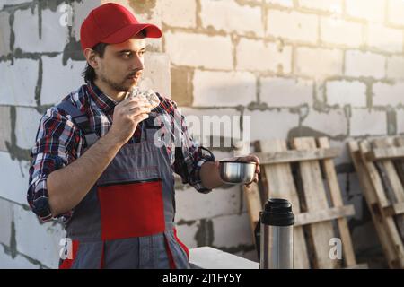 Professional bricklayer during the lunch at the work Stock Photo