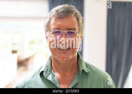 Portrait of smiling caucasian senior man in eyeglasses at home Stock Photo