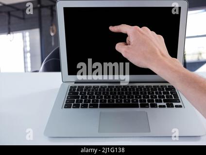 Close up of hand touching laptop screen with copy space at office Stock Photo