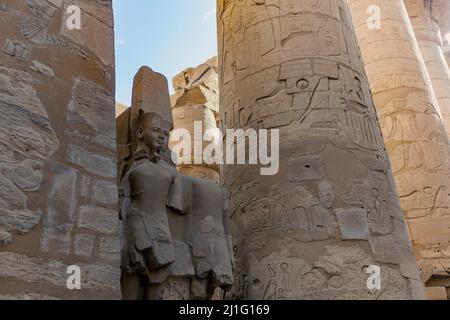 Remains of statue of the God Amun Ra in the Great Hypostyle Hall at Karnak Stock Photo
