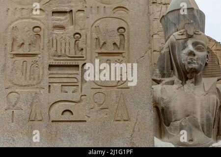 Statue of Ramses II and obelisk at the entrance to the first pylon of Luxor Temple Stock Photo