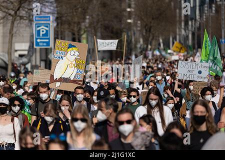 25 March 2022, Hessen, Frankfurt/Main: Participants in a Fridays For Future demonstration hold up signs. The organization Fridays for Future has called for worldwide climate protests on Friday. Photo: Hannes P. Albert/dpa Stock Photo
