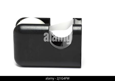 Close up of profile view black office tape dispenser with cutter and transparent tape on white background Stock Photo