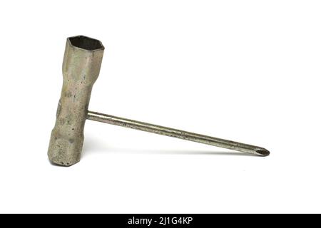Close up of an old solid heavily used gold spark plug wrench for lawn mower repair on white background Stock Photo