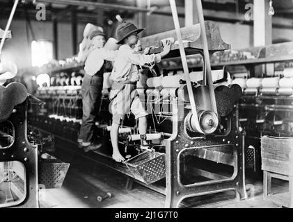 Doffer Boys, Macon, Georgia by Lewis Hine (1874-1940), 1908. The photograph shows young boys working in a cotton mill as child labor Stock Photo