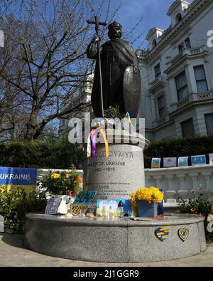 Flowers, banners, and candles and left at the statue of St Volodymyr, ruler of Ukraine, in solidarity with Ukraine and against the Russian invasion. L Stock Photo