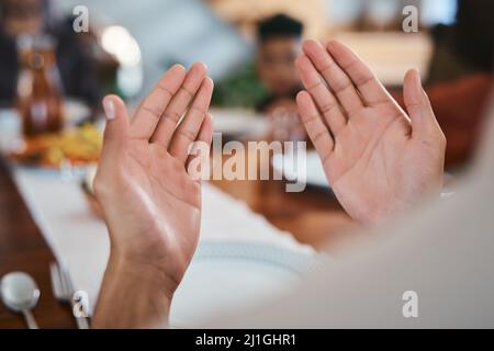 Let prayer lead the way. Shot of a muslim person praying before breaking their fast. Stock Photo