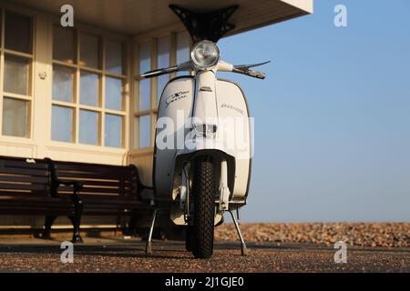 Italian Innocenti Lambretta SX150 motor scooter, photographed on Worthing seafront, the pier, The Dome, fishing boat