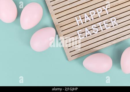 Happy Easter text on letter board with Easter eggs Stock Photo