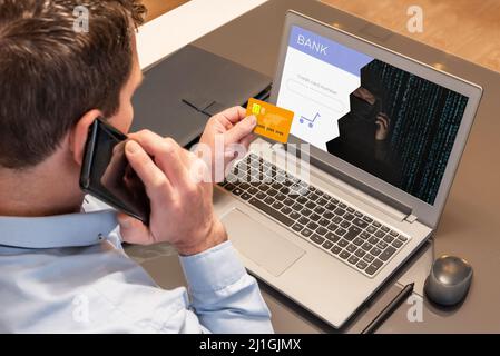 Man making purchases with his credit card over the phone while being scammed by a cyber thief. Vishing scam Stock Photo