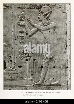 Ancient Egypt. The New Kingdom (1549–1069 BC). Illustration from book of 1912 Seti I offering an image of truth to Osiris. Relief from his temple at A Stock Photo