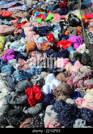 pile of silk scarves and shawls for sale in the outdoor street market Stock Photo