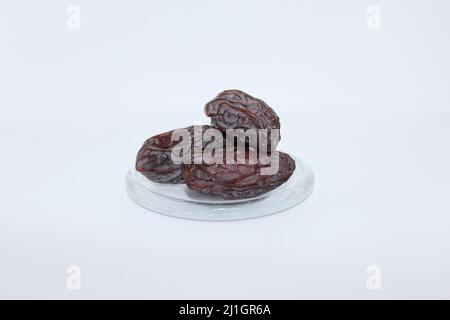 Fresh dried dates Medjool, close-up isolated on white background. Stock Photo
