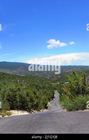 Ambling road turns and twists with a view of the Sandia Mountains outside of Albuquerque, New Mexico. Stock Photo