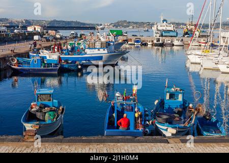 The port of Pozzuoli with fishermen in their boats in the morning Stock Photo