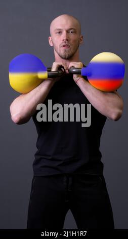 The guy with the kettlebells is standing russia ukraine ukrainian national, for government battle for concept and economy army, patriotism europe Stock Photo