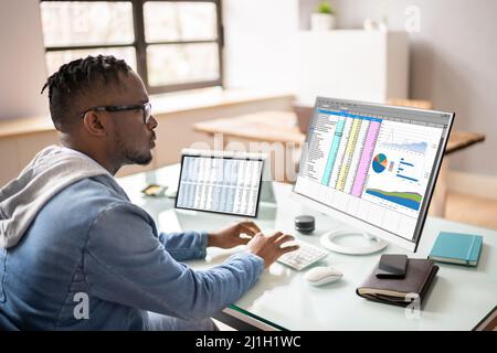 African American Auditor Using Electronic Spreadsheet On Computer Stock Photo