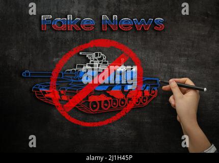 drawing on the blackboard crossed tank with text fake news Stock Photo