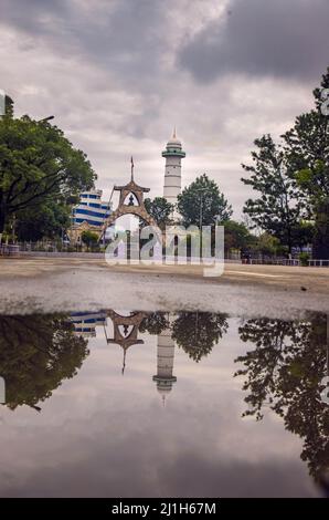 The Shahid Gate and lighthouse reflect on the water surface, Thamel District, Kathmandu, Nepal Stock Photo