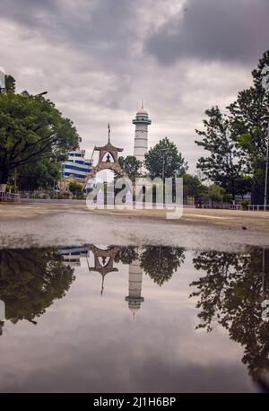 The Martyrs gate and beacon reflect on the water surface, Old Town, Kathmandu City, Nepal Stock Photo