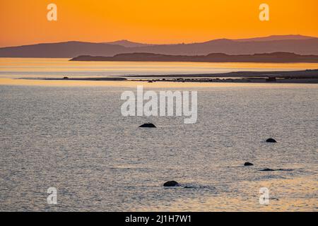 Sunset over the sea, from the seafront at Criccieth North Wales Stock Photo