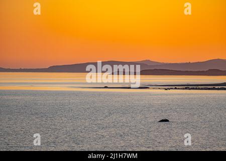 Sunset over the sea, from the seafront at Criccieth North Wales Stock Photo