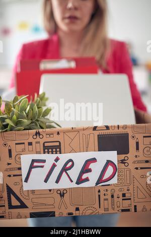 Young sad caucasian woman getting fired from the office, Close up of hands holding box Stock Photo