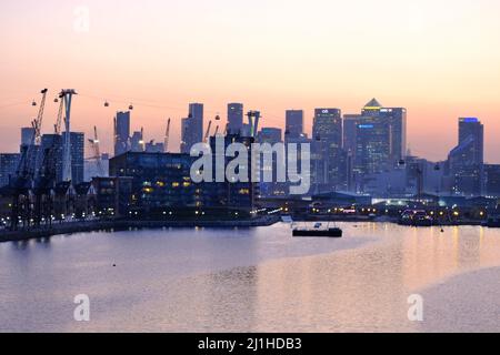 London, UK, 25th Mar, 2022. A hazy sunset over Canary Wharf and City of London skyline as fine and dry weather is set to continue for the rest of the weekend, before giving way to more seasonal temperatures next week. After a high air pollution warning was issued for London this week, poor air quality persisted in parts of the city on Friday. Credit: Eleventh Hour Photography/Alamy Live News Stock Photo