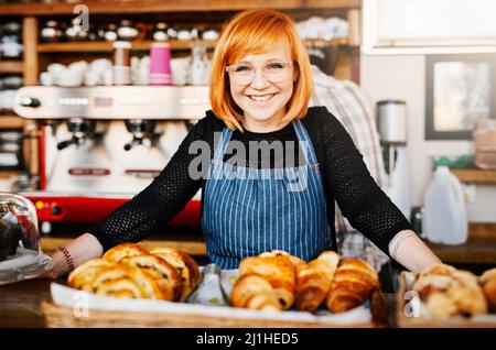 These just came from the oven. Portrait of a confident young woman working in a cafe. Stock Photo