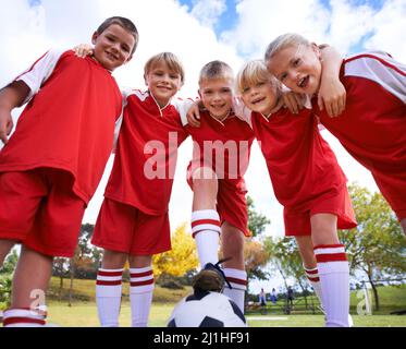 The field holds promise. Shot of a childrens soccer team. Stock Photo