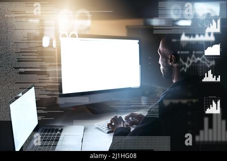 The root is at the top of the tree. Cropped shot of a young male hacker cracking a computer code in the dark. Stock Photo