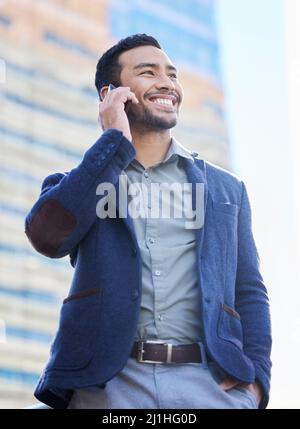 Youre doing me a great favour. Shot of a handsome young businessman using a smartphone to make a call. Stock Photo