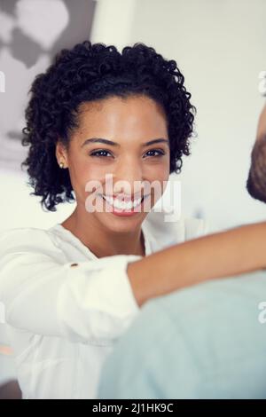 I get to see the love of my life everyday. Cropped shot of a young affectionate couple in the office. Stock Photo