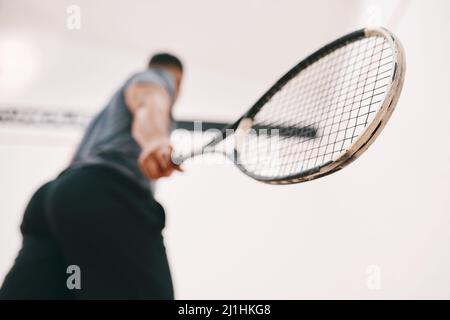 How you grip it determines whether youll win it. Low angle shot of a man playing a game of squash. Stock Photo