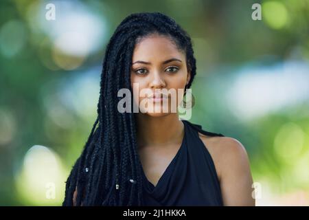 My style is my own. Portrait of an attractive young woman posing outdoors. Stock Photo