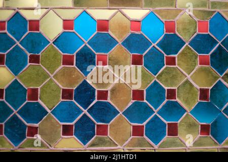 Mosaic pattern, made of multicolored glossed glass tiles, on a wall in Thailand shrine Stock Photo