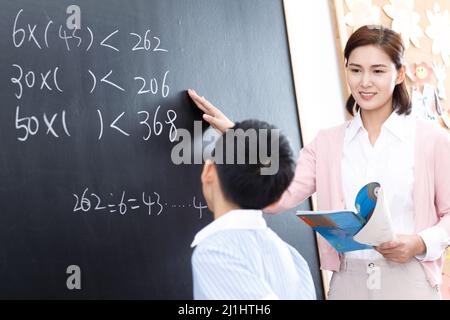 Female teachers and the pupils in the classroom Stock Photo