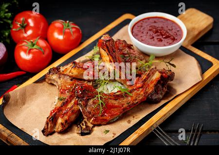 Delicious barbecued ribs seasoned with a spicy sauce. Copy space Stock Photo