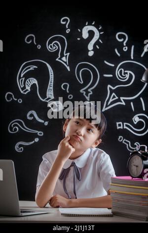 Primary school girls in thinking Stock Photo