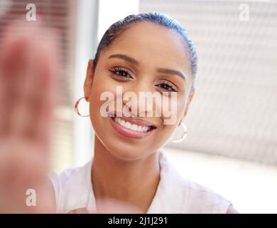Taking a quick selfie. Shot of a young businesswoman taking a selfie at work. Stock Photo