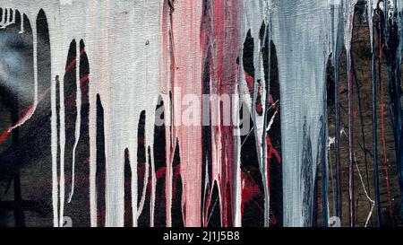 The current paint on a dark background. Dripping  abstract structure of pouring. Brooks of liquid colorful. Paint dripping wall. Stock Photo