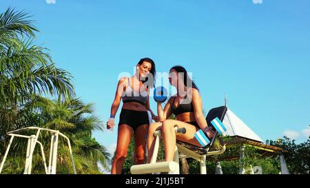 A closeup shot of two females working out at the beach in Koh Samui, Thailand Stock Photo
